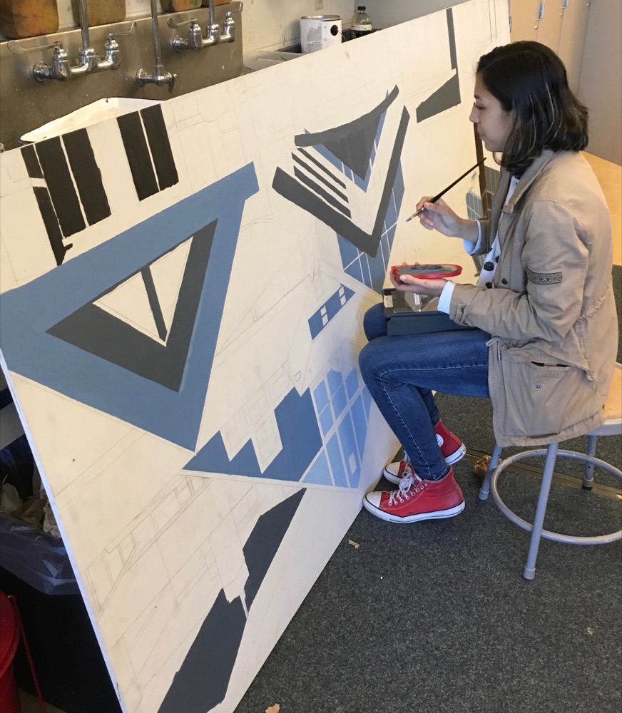 An MTHS Art Student applies paint to the MTSD Mural