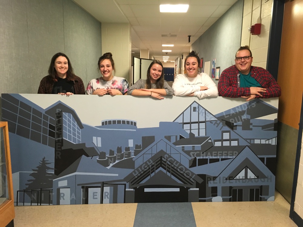 Proud MTHS Art Students stand with their artwork