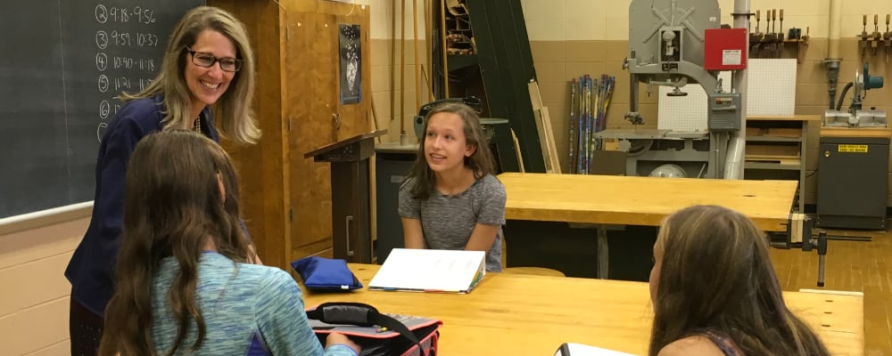 Dr. Robin Felty speaks with three Middle School students