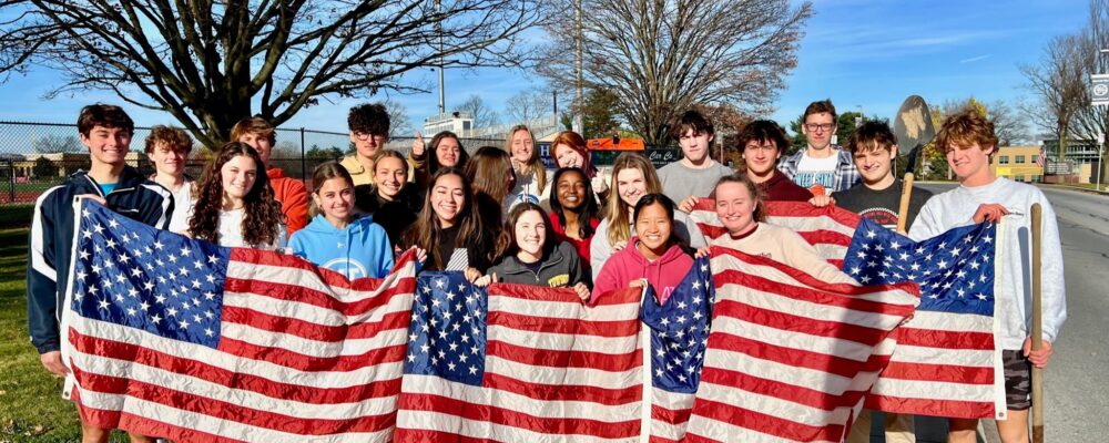 Photo of students holding an American Flag.
