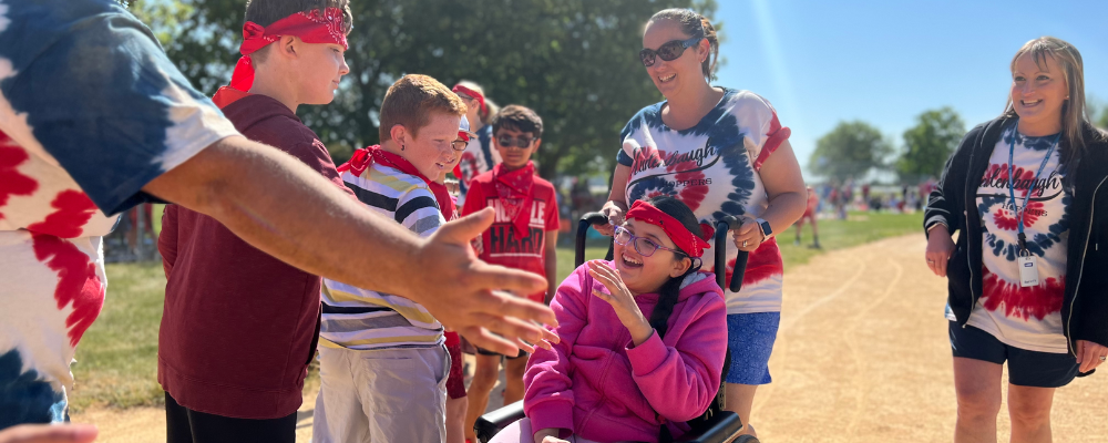Photo of reidenbaugh kick ball tournament with a student getting a high five
