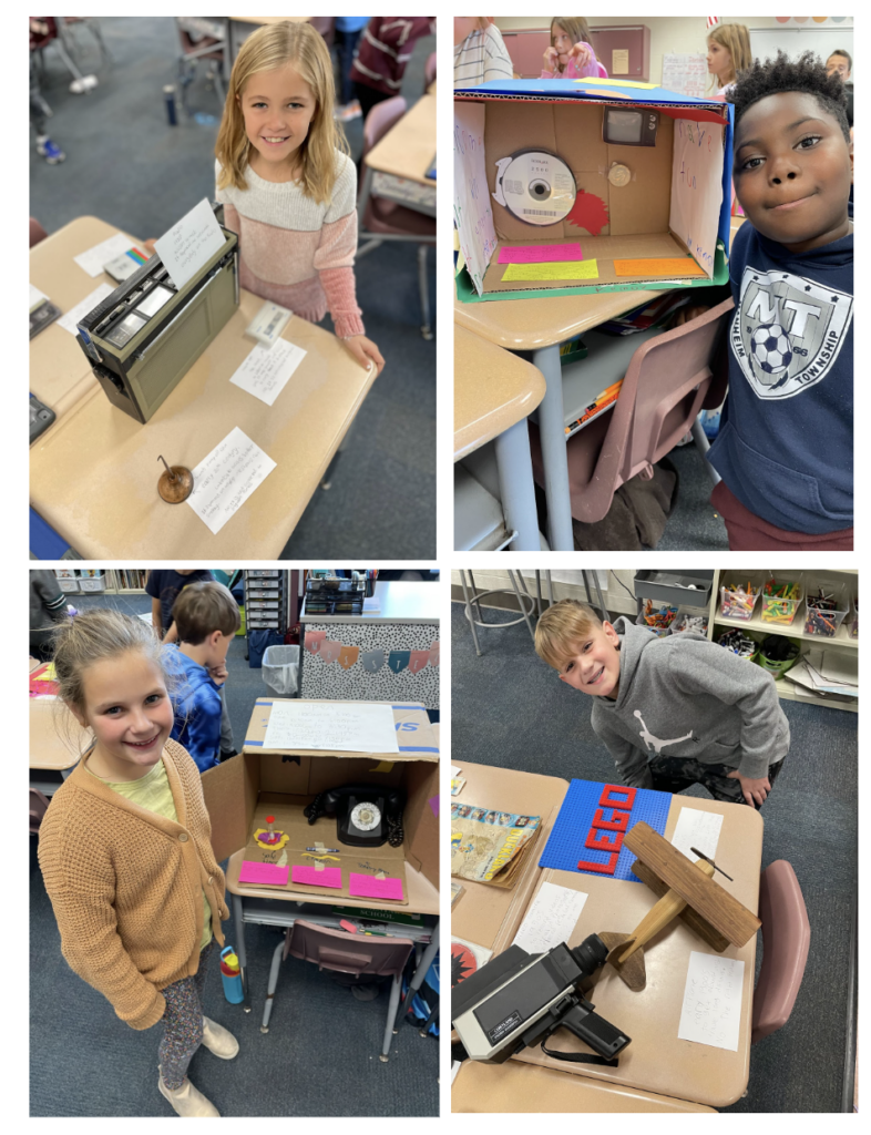 students standing next to their artifact museum items 