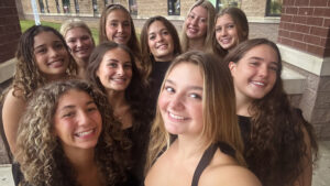 Homecoming Court Photo in a group in front of high school